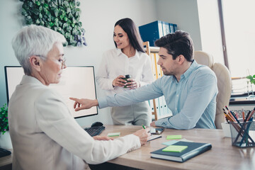 Photo of two employees mature boss woman discuss strategy office team meeting discussion colleagues working together in workstation