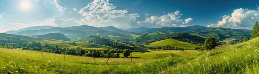 Fototapeta premium A panoramic view of the beautiful countryside on a sunny afternoon. landscape wonderful springtime scenery in the mountains, with a grassy field and rolling hills, a picturesque rural scenery.