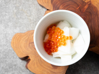 Radish and salmon roe marinated in vinegar in a bowl