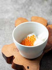 Radish and salmon roe marinated in vinegar in a bowl