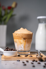 cup of Dalgona coffee decorated with coffee beans