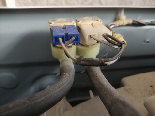 Old washing machine pressure sensor and water valve with wires  under cap closeup