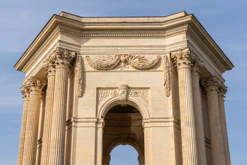Obraz premium Landscape detail view of classical ancient stone water tower building in historic Promenade du Peyrou garden, Montpellier, France