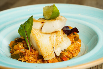Grilled Halibut fish with Andalusian Ratatouille and a slice of lime