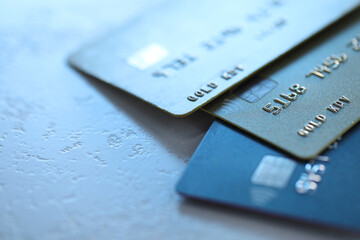 Plastic credit cards on table, closeup view. Space for text