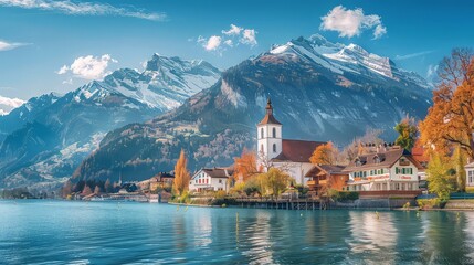 Panoramic view of the city of Brienz on Lake Brienz, Switzerland. An old fishing town with a beautiful church and snow-capped Alpine mountains in the background.
