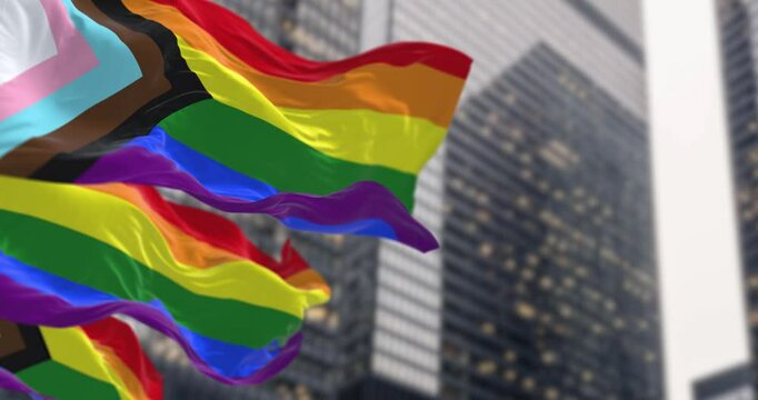 Progress Pride flag waving in the city. - Powered by Adobe