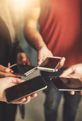 Business people, circle and hands with mobile screen in office for communication, networking or sync schedule. Closeup, lens flare and employees with display for teamwork, data transfer or meeting