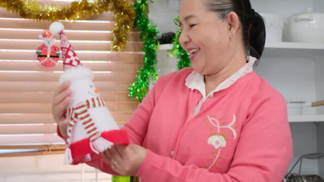 Happy Asian family spending times to prepare Chritsmas and Happy news year Celebrete. kids parent and grandparent doing ginger breads and bakery enjoy and dancing in kichen at home