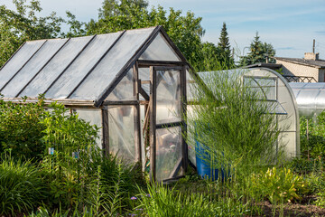 landscape with film greenhouse, gardener's concept, small garden