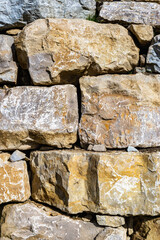 Stone wall fence in daylight. Banner background, backdrop or texture.