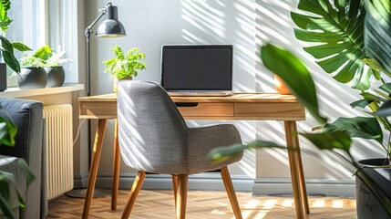 Minimalist Home Office - Light wood desk with a grey chair, a sleek laptop, minimal decor items, and a small indoor plant