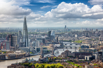Obraz premium The London skyline along the river Thames from London Bridge until the City during a sunny summer day, United Kingdom 