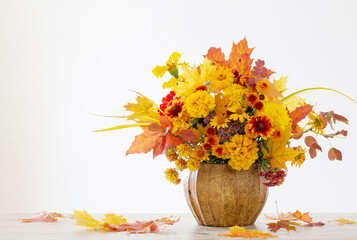 autumnal bouquet in ceramic vase on white background