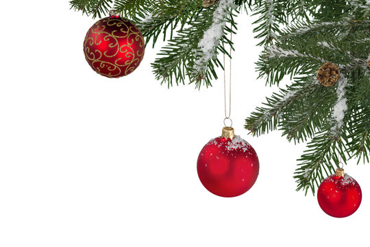 Christmas decorations with tree branches and baubles frame isolated on white background