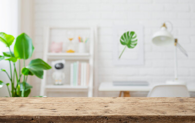 Close-up of old wooden table top and copy area in blurry study room space