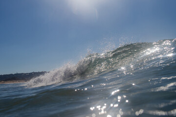 Breaking wave on the ocean on a sunny day.