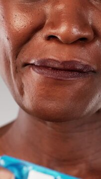 The African American woman stands determined, chewing on nicotine gum