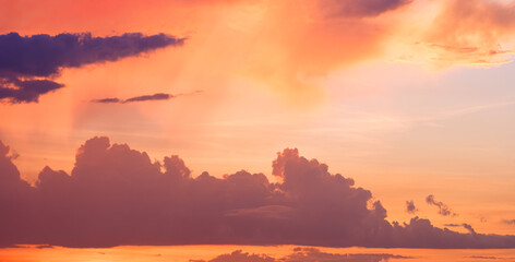 Silhouette dark clouds with orange sunlight on dramatic horizon sunset sky background in evening time