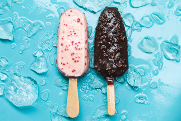 chocolate and strawberry flavored ice cream bar with ice on a blue background