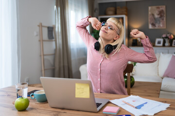 Young introvert freelancer businesswoman with ADHD working remotely from home office on laptop...