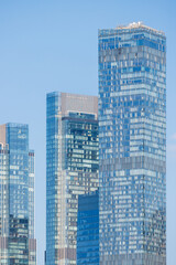 Obraz premium Modern skyscrapers against the sky. View of residential and office high-rise buildings. Close-up.