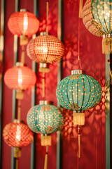 Fototapeta premium Minimalist red backdrop with Chinese gold and jade embossed lanterns,