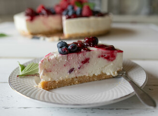 Piece of no bake cheesecake with berry topping on kitchen counter