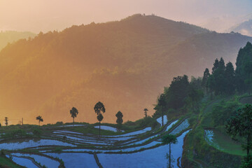 The terraced fields filled with water and the beautiful sunset in the mountainous areas of Zhejiang...