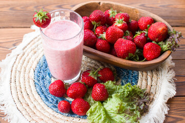 red strawberries on a plate and a healthy strawberry cocktail. Healthy vitamin breakfast