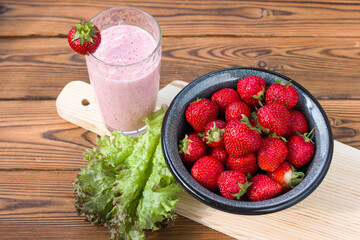 red strawberries on a plate and a healthy strawberry cocktail. Healthy vitamin breakfast