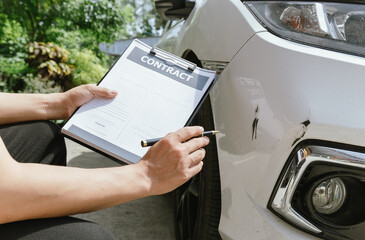 A car accident scene with damaged vehicles on a busy road. The crash caused injuries and vehicle damage, requiring car insurance claims and repair services.