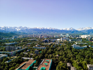 Aerial photography of the city of Almaty with a view of the mountains.