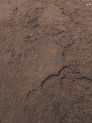 Broken fractured brown stone with a crack in it background, damaged grey uneven disrupted cracked floor