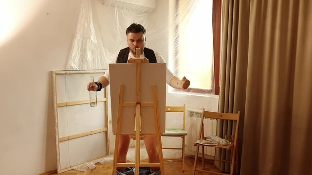 Drunk man artist paints a picture with his penis