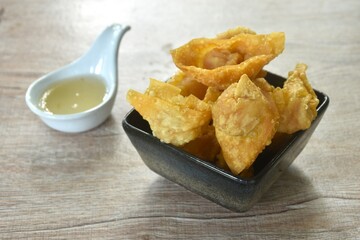 crispy fried dumpling paste stuffed chop pork and shrimp dipping sweet chili plum sauce on cup
