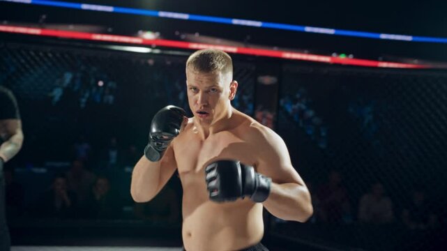 From the Fighter&rsquo;s POV, Strong Opponent Closing In After Referee Signals a Round Start. Quick Strikes and Movements in the Frame. First Person View Athlete Ready to Deliver Powerful Counterattacks