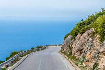 A view approaching a bend on the descent from the heights of the Llogara National Park, Albania in summertime