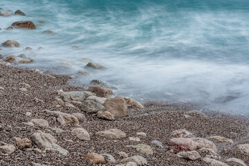 Sand beach with white waves, close-up. Foamy coastline. Seascape for publication, poster, calendar, post, screensaver, wallpaper, postcard, banner, cover, website. High quality photo