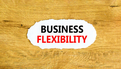 Business flexibility symbol. Concept words Business flexibility on beautiful white paper. Beautiful wooden wall background. Business flexibility concept. Copy space.