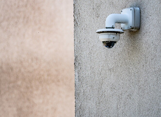 White Security Camera Mounted on Exterior Wall