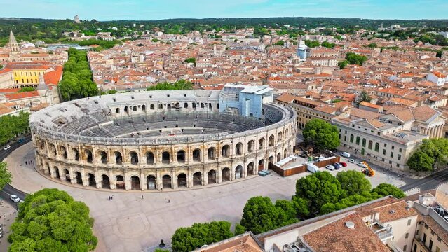 Aerial view of Imposing Roman amphitheatre hosting historic reconstructions in Nimes, France. View from above Amphitheatre of N&icirc;mes and Museum Romanit&eacute; in France.