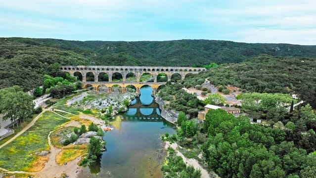 Aerial view of the aqueduct bridge with arched tiers in France. Drone view of Pont du Gard the highest Roman aqueduct bridge in the world.