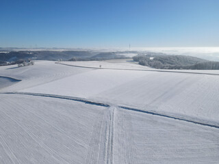 Aerial view of farm fields with snow in winter 