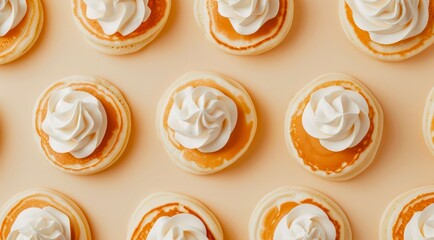 Pattern design of pancakes with whipped cream on light beige background, top view, minimal flat lay style.