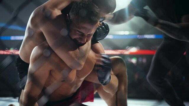 Professional Mixed Martial Artist Submitting a Grounded Opponent Next to a Fence. Fighter Signals His Defeat and the Referee Stops the Fight. Fierce Middleweight Battle Inside the Octagon Ring