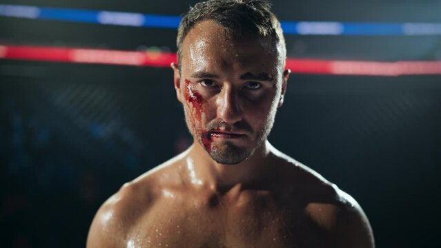 Close Up Portrait of an Exhausted Mixed Martial Arts Fighter Inside the Octagon, Covered in Blood and Sweat, Looking at Camera with Serious Expression, Preparing for Another Championship Round