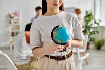 A teenage girl holds a globe during a UN Model conference.