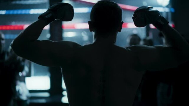 Cinematic Dark Footage of a Mixed Martial Artist Walking Towards the Octagon. Fighter is Welcomed by Excited Fans, He's Warming Up and Flexing His Muscles Before a Championship Bout
