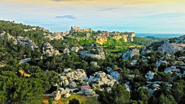 Aerial view of Medieval fortress ruins with replica siege engines in France. Les Baux de Provence village is on the rock formation, and its castle Ch&acirc;teau des Baux-de-Provence in France.